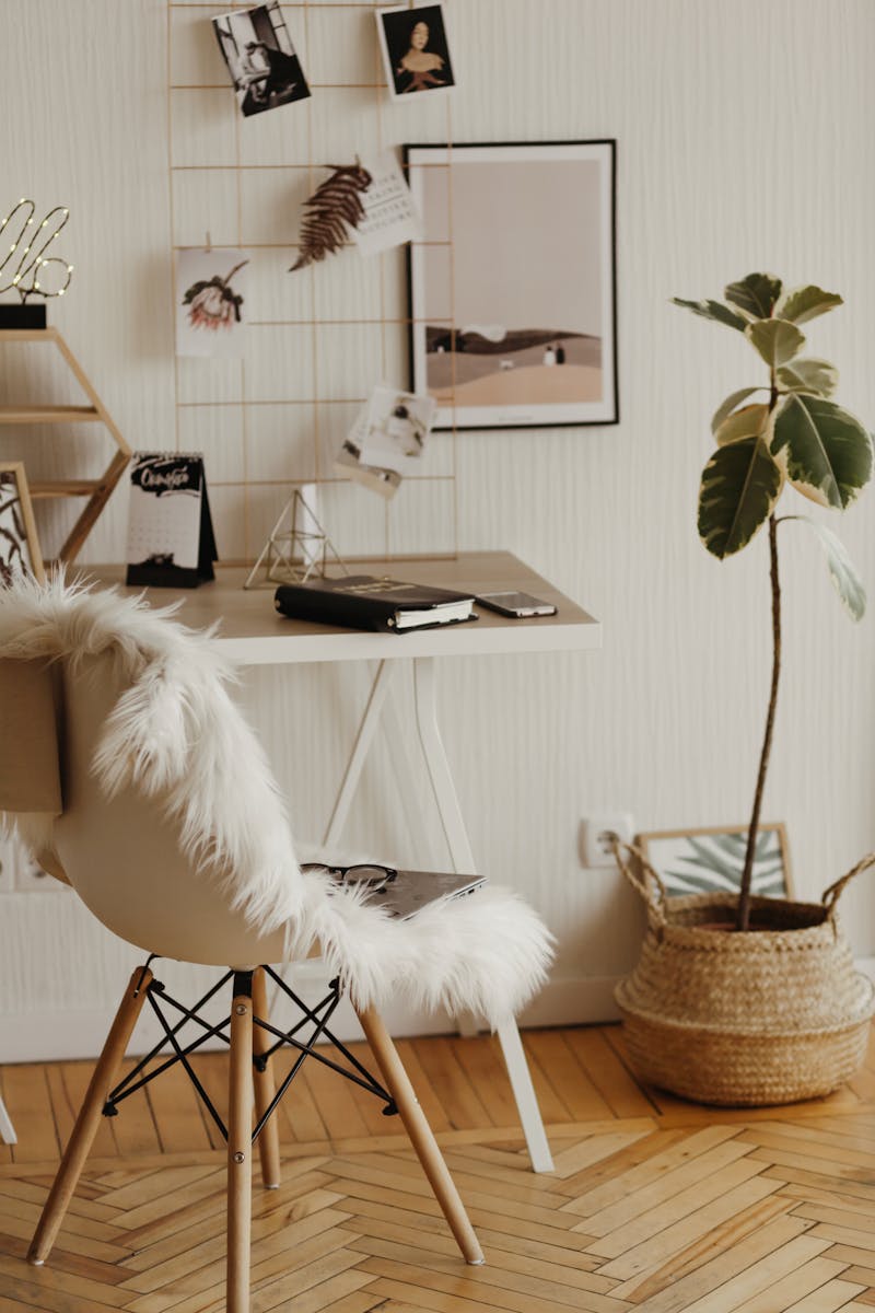 A stylish home office with a furry chair, sleek desk, and minimalist decor, creating a cozy and productive workspace.